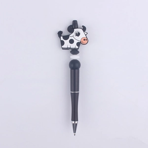 Detail of creative cartoon cow bead pen with black and white silicone animal character