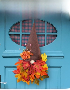 Detailed view of an autumn gnome door hanger with burlap hat and maple leaf beard
