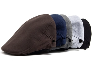 Close-up of five cotton flat caps in various colors with adjustable metal buckles