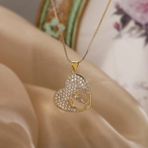 Gold plated heart pendant necklace with zircon pavé and baby footprint cutout design