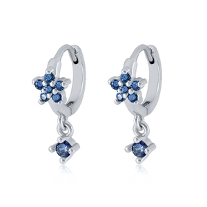Detail of silver S925 earrings with blue cubic zirconia in star and round shapes