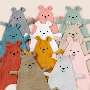 Macro shot of assorted colors muslin cotton bear comforter towels for babies