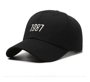 Detail of classic black cotton baseball cap featuring 3D embroidered 1987 on the front