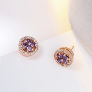 Boucles d'oreilles trèfle rotatif en pierre violette et zircons finition or rose