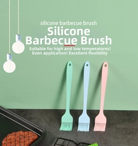 Three silicone barbecue brushes in green blue and pink with hanging holes for baking