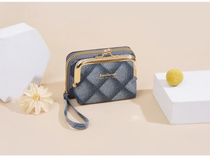 Close-up of blue denim plaid coin purse with gold metal clasp and zipper details