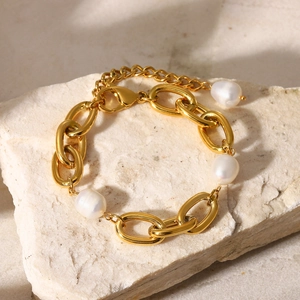 Detailed view of baroque freshwater pearls on a gold-plated chunky oval chain bracelet