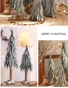 Detail of mini frosted Christmas trees with wooden base and burlap wrap in warm indoor light