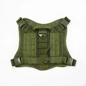 Detail of military green tactical dog harness with Molle system and metal D-ring attachment