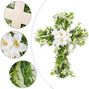 Easter cross wreath with white lilies and lush green leaves on a wooden cross base