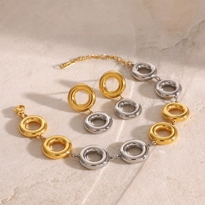 Detail of two-tone gold and silver interlocking rings on a geometric jewelry set
