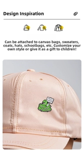 Detailed view of green snake enamel pin with Free Hugs sign on a pink baseball cap