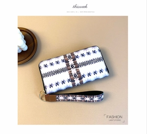 Detail of long floral wallet with tribal geometric pattern and detachable wrist strap