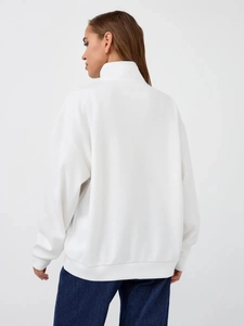 Back view of a thick white stand-collar sweatshirt showing minimalist cut and texture