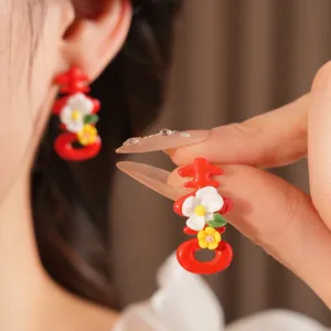 Traditional red Xi character earrings with small floral accents for Chinese weddings