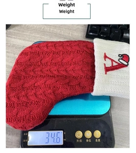 Detailed view of knitted Christmas stocking showing 34.6g weight on a digital scale