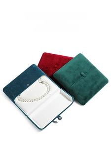 Three premium velvet jewelry boxes in dark green, burgundy and navy with metal clasps