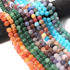 Macro shot of colorful dragon-vein glass beads in orange, blue, and purple for DIY jewelry