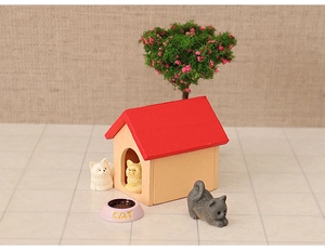 Detailed view of a miniature wooden cat house with a red roof for dollhouse decor
