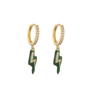Detail of lightning bolt gold earrings with green enamel and clear cubic zirconia stones