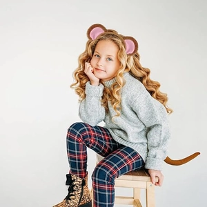 Detailed view of child wearing plush brown monkey ears headband and matching long tail