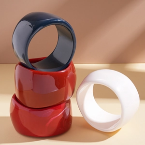 Chunky irregular geometric resin bangles in deep blue, red, and white with glossy finish