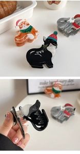 Close-up of festive cat hair claws with Christmas hats and internal tooth structure