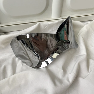 Detail view of futuristic silver mirrored cycling sunglasses on white wrinkled fabric