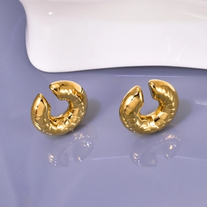 Vintage chunky golden hoop earrings with textured geometric patterns and glossy finish