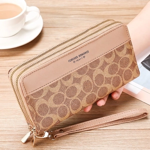 Detail of vintage khaki double zipper wallet with monogram pattern and gold hardware
