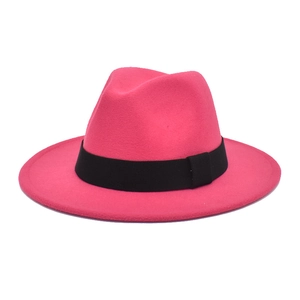 Detailed texture of rose red felt fedora hat with wide black ribbed ribbon band