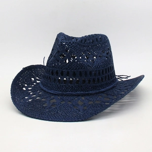 Close-up of a navy blue hand-woven straw cowboy hat with hollow breathable patterns.