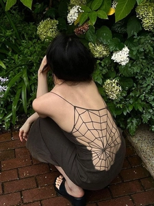 Brown backless long dress featuring unique spiderweb crochet detail and a cinched waist