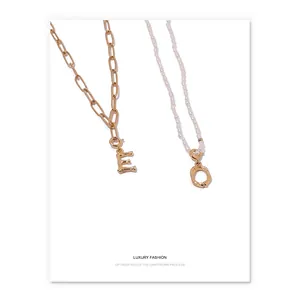 Gold-plated brass bamboo-style alphabet necklaces with pearl and thick chain detail