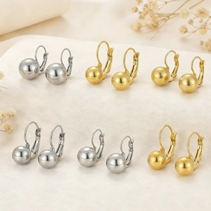 Polished gold and silver ball drop earrings with leverback closure in a group display
