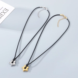 Detail of minimalist star pendant necklaces with black adjustable cords and lobster clasps