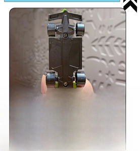 Detail view of the durable physical pull-back drive mechanism on the mini racing car base