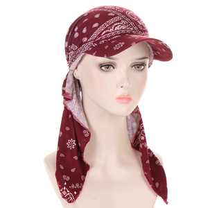 Detail view of dark red paisley headscarf cap with brim and long tie-back strap