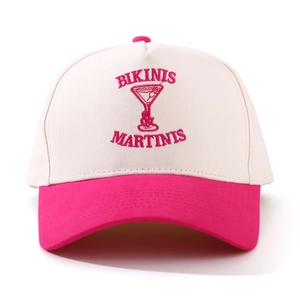 Detailed pink embroidery of Bikinis and Martinis on a cream canvas baseball cap