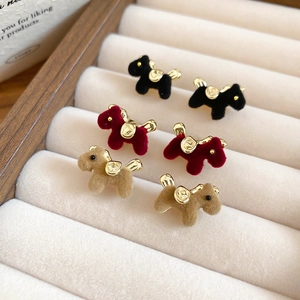 Detail view of flocked dog-shaped stud earrings in black, burgundy and khaki colors