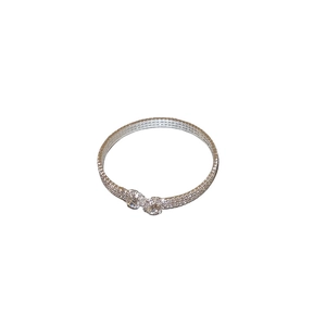 Elegant silver crossover bangle with shimmering rhinestones and pearl details on white background