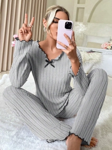 Detail of grey ribbed loungewear set featuring black lettuce edges and bow knot decoration