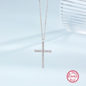 Close-up of S925 sterling silver cross pendant necklace with inlaid clear gemstones