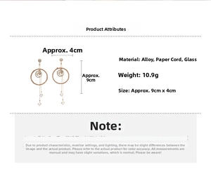 Detailed view of handmade geometric drop earrings with woven paper rings and glass beads