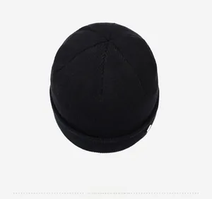 Top down view showing the premium ribbed knit construction of the black beanie hat