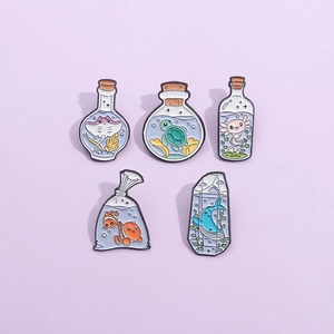 Five-piece set of ocean sea life enamel pins with clownfish and axolotl designs