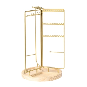 Rotating golden metal jewelry rack with wooden base for necklaces and earrings