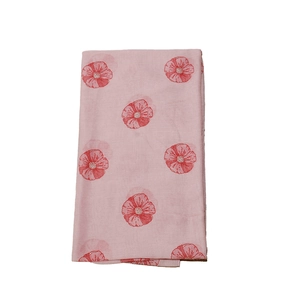 Detail view of pink floral pattern on soft fabric scarf with red flower print