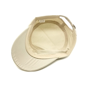 Interior view of beige cotton military flat cap showing inner lining and metal buckle