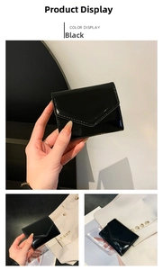 Detail of a black glossy patent leather envelope card holder and mini wallet